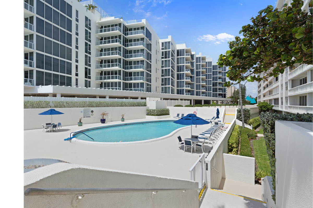 Your backyard. Heated pool, lounge chairs, and blue skies — 30 seconds from your front door.