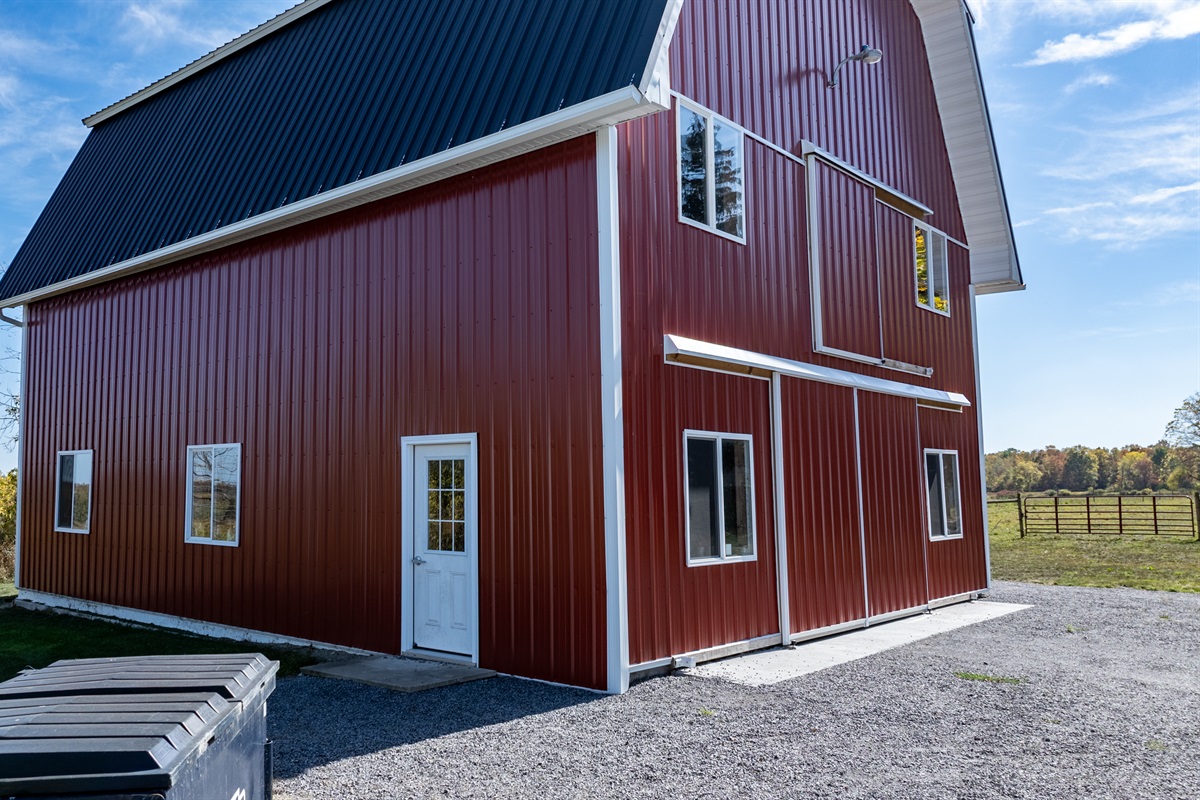Close-up of the red barn exterior — freshly restored and full of rustic charm