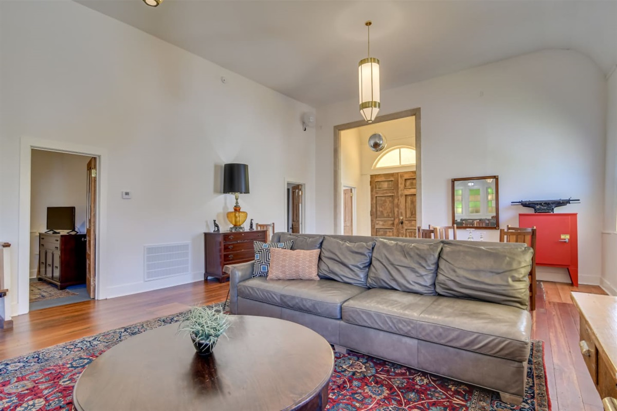 Bright lounge with colorful vintage rug and cozy seating.