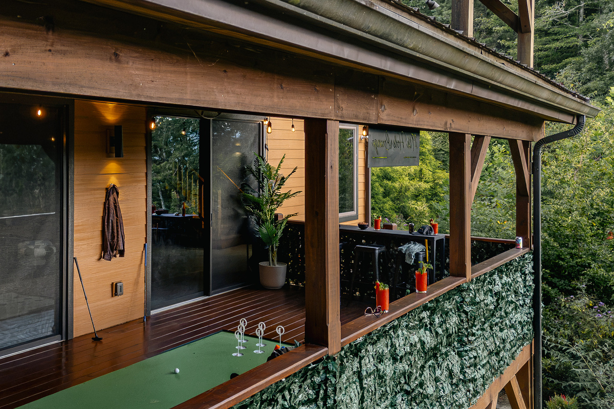 {19th Hole Deck} The covered mini-golf deck feels like its own little clubhouse, perched among the trees just off the main house.