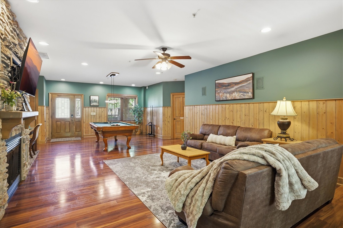 Unwind in unit 312's spacious living room with cozy couches, a gas fireplace, and a large TV for movie nights. Step right out to the back porch to enjoy some fresh air and keep the good vibes going.