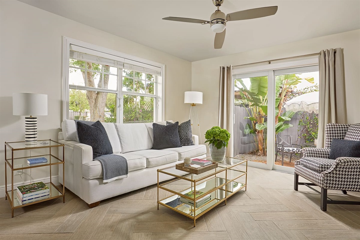 Unwind in a bright, spacious living room, beautifully designed for both comfort and style. The cozy Queen sofa sleeper, 60” smart TV, and large windows offer a tranquil view of the private patio, creating the perfect space to relax and recharge.