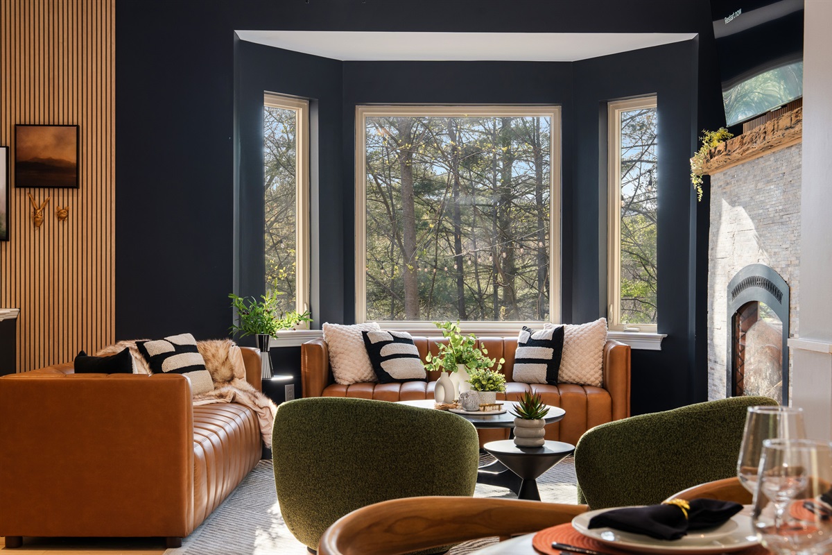 Cozy seating area framed by large windows - bringing the surrounding trees and mountain setting indoors