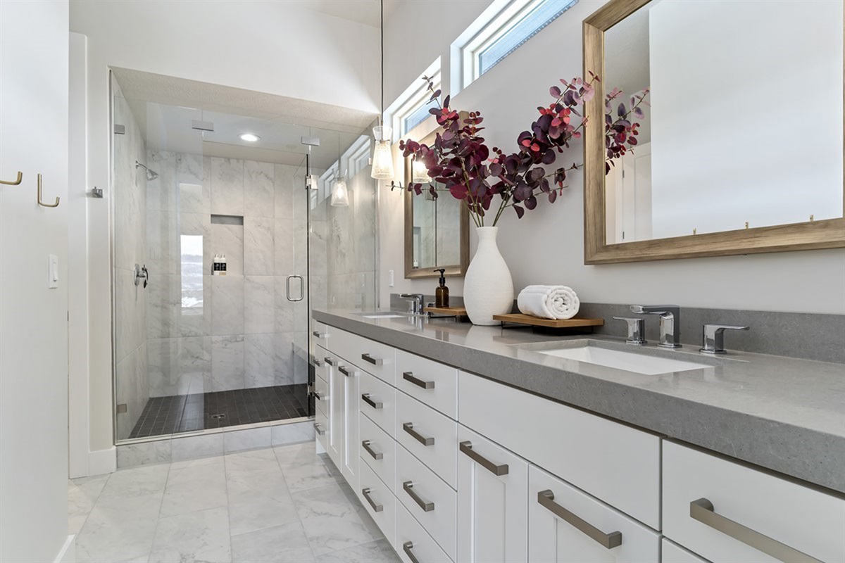 Primary ensuite bathroom with double vanity and a spacious walk-in shower.