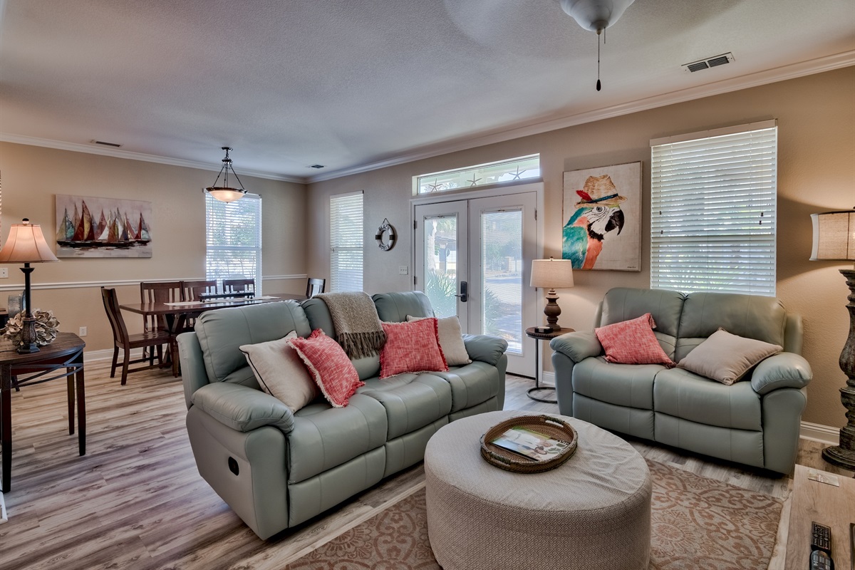 Spacious living space featuring a cozy reclining sofa, ideal for relaxation.