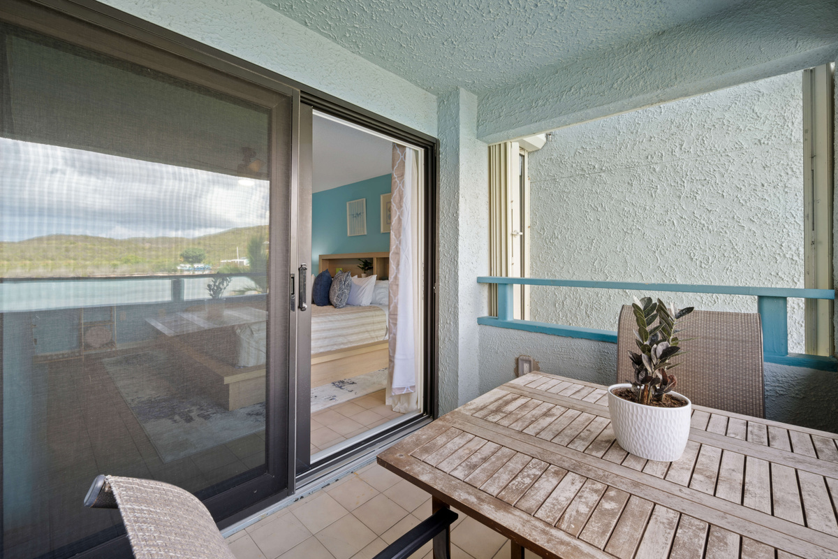 A relaxing outdoor retreat with comfortable seating and tropical views.