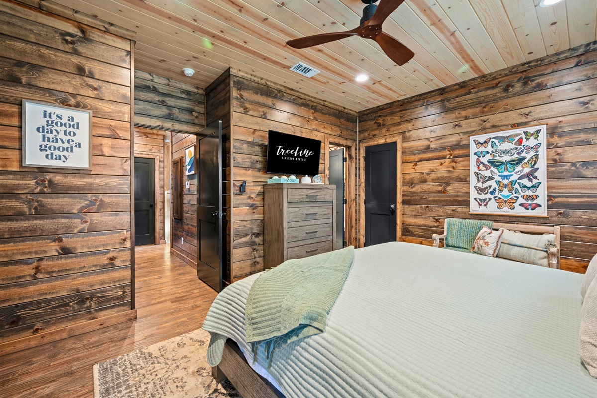 Another angle of this bedroom shows the cozy setup and warm textures that make it feel like a true cabin escape.