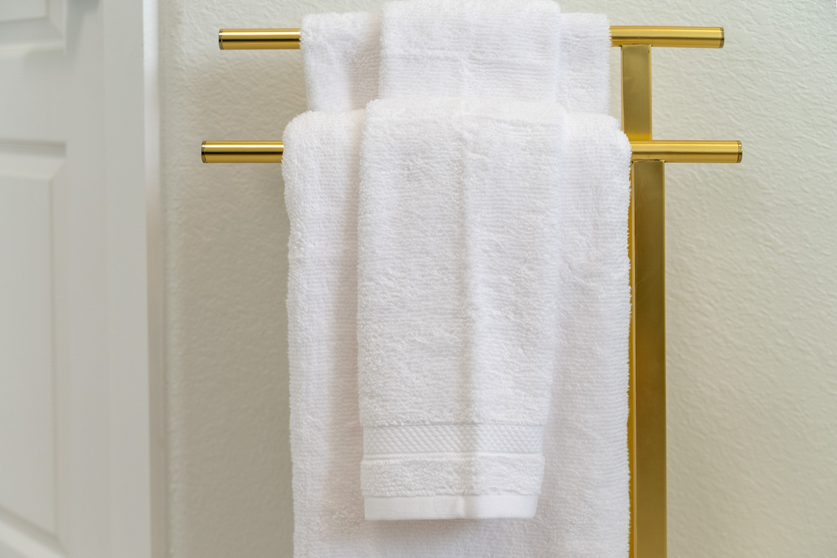 Brushed gold towel bar adds a warm, upscale finishing touch.