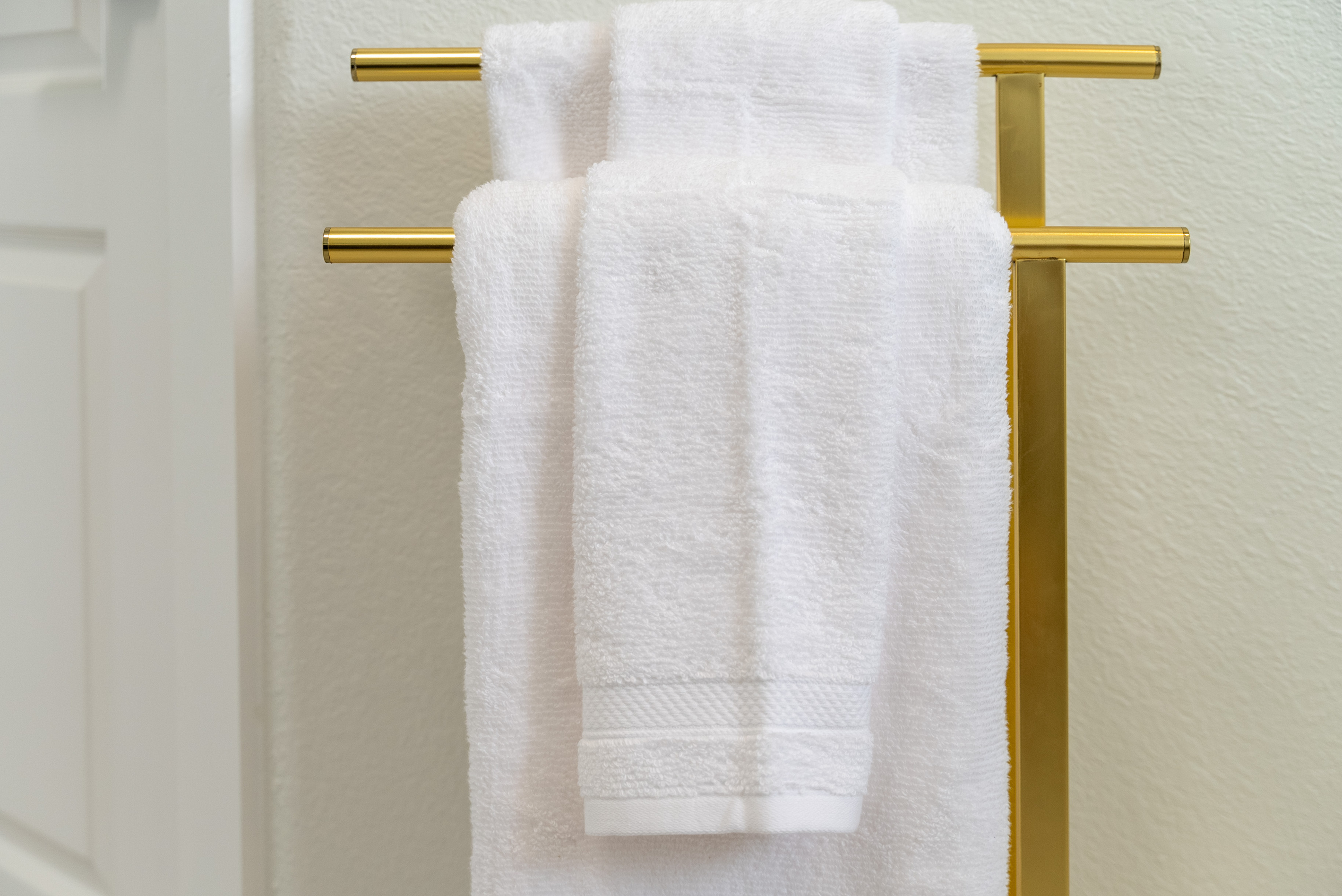 Brushed gold towel bar adds a warm, upscale finishing touch.