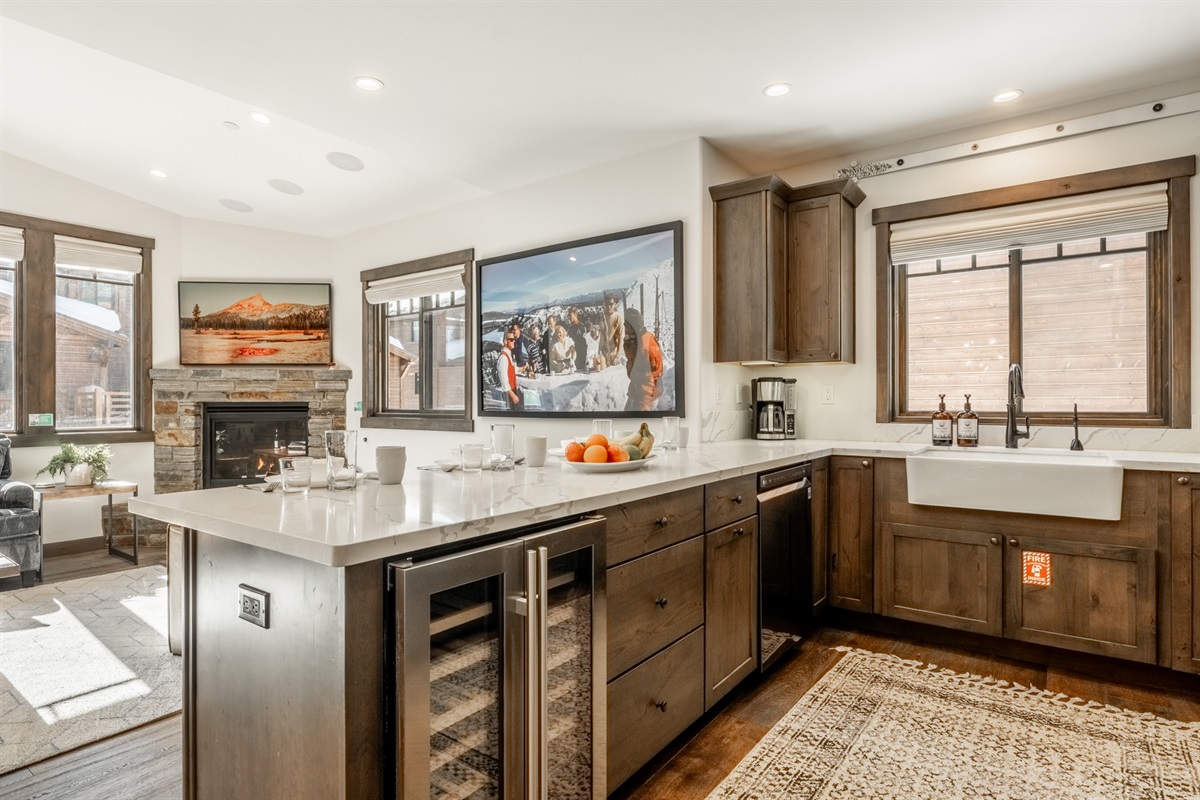 Open to the dining and living areas, the kitchen makes hosting effortless—whether you’re serving après snacks, prepping family meals, or enjoying the fire while you prep your apres.