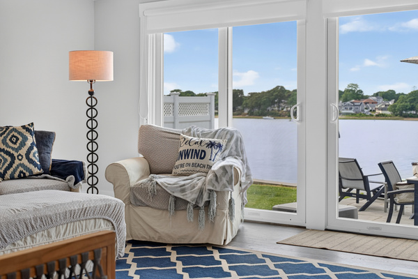 Cozy reading nook overlooking the water with plush seating and access to the lakeside deck.