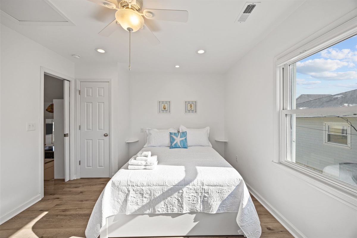 Comfortable queen bed with crisp linens and a bright, airy feel