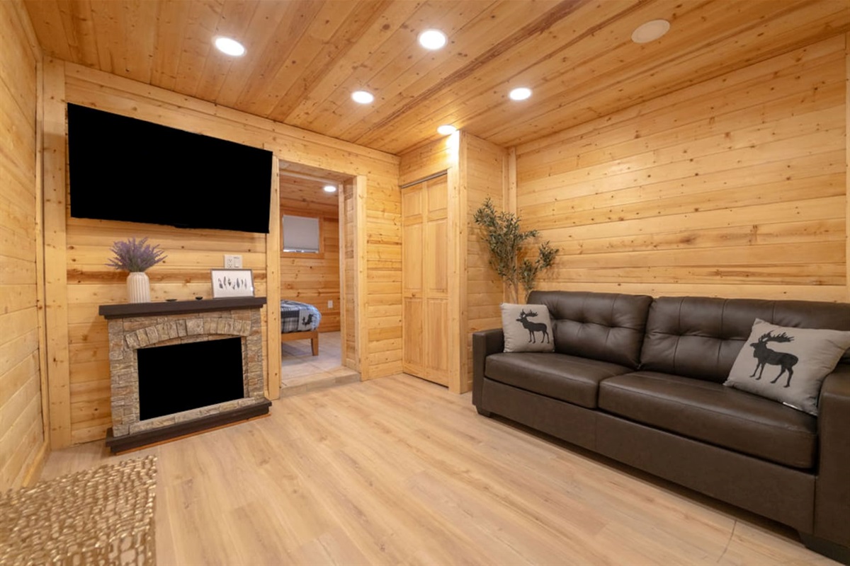 Snuggle up in this charming living room, featuring a sleek full-size leather sleeper sofa, a warm electric fireplace, and a 55-inch TV—the perfect retreat to unwind and relax after a day of adventure!