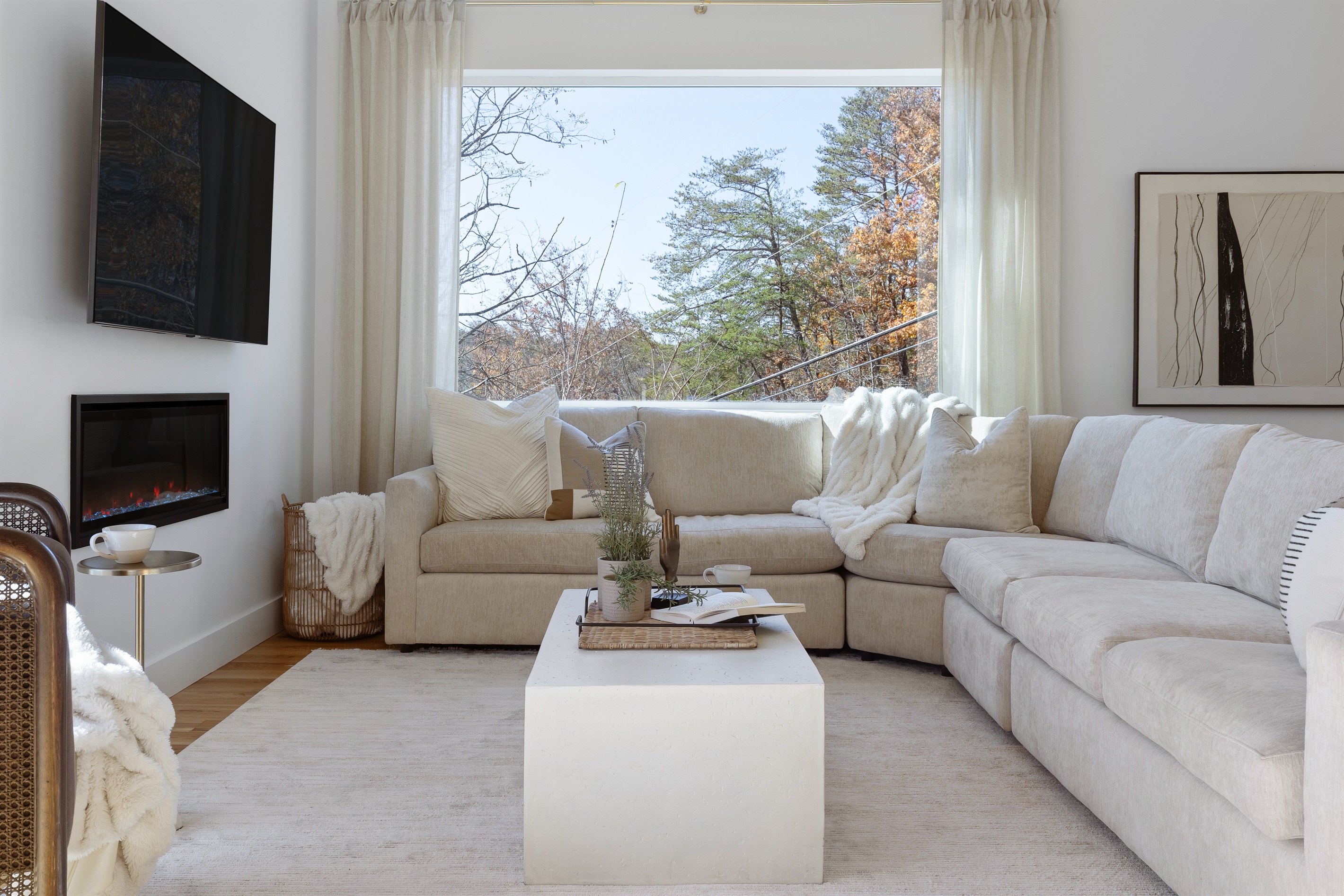 {Living Room - Gallery House} Curl up by the fire and take in the treetop views—comfort comes naturally at Gallery House
