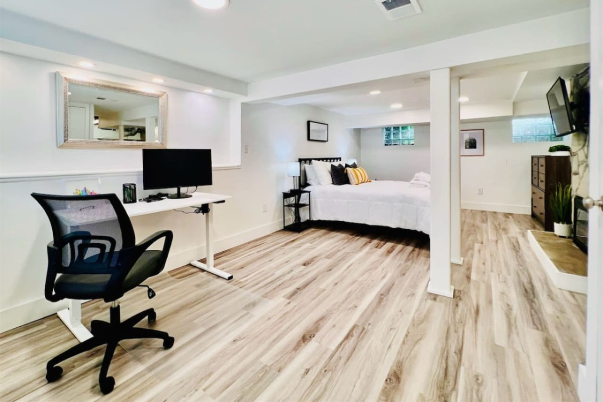Spacious queen-sized bedroom with a dedicated working space and a TV, offering the perfect blend of comfort, productivity, and entertainment.