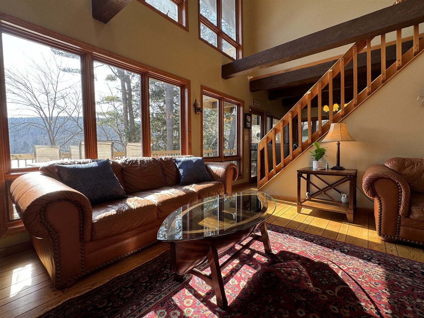 Camp Havon light filled living room is easy to hang out in, enjoy the water views or a family movie night.