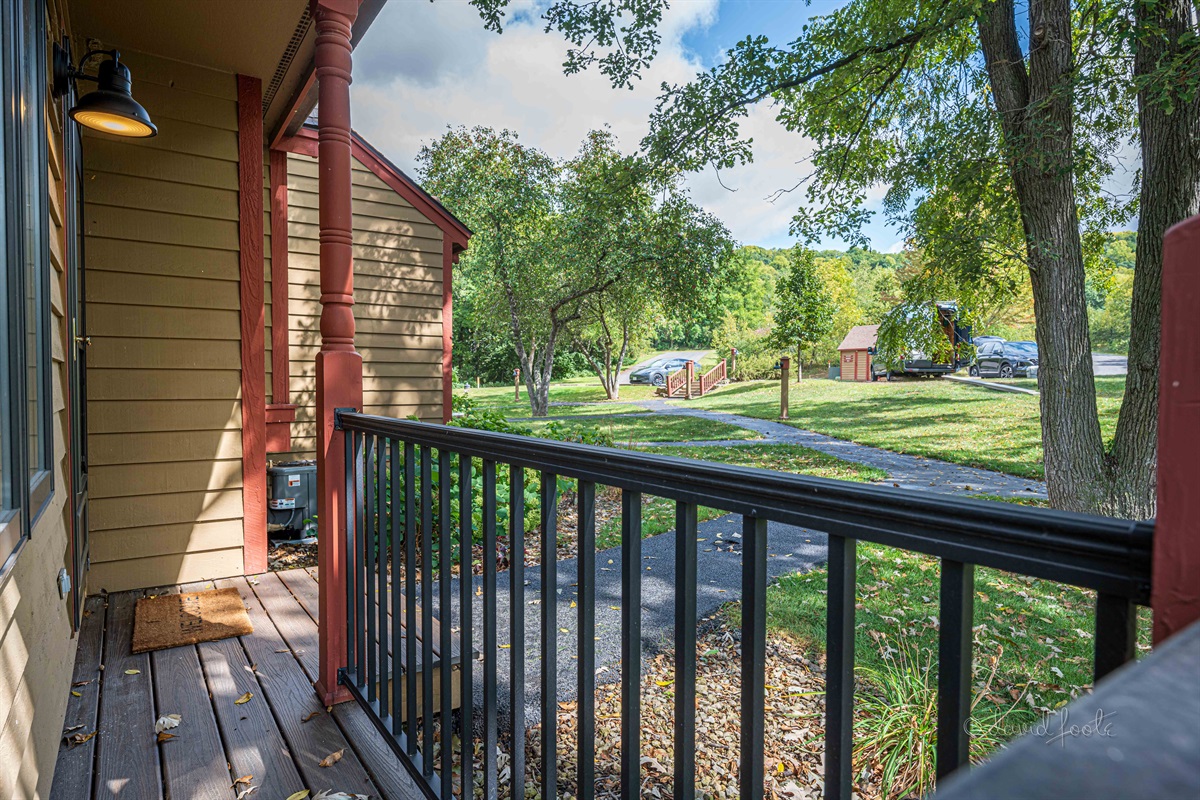 Front entry is one step up from sidewalk. Well-lit.