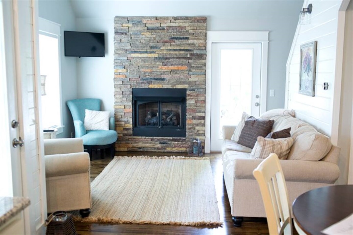 Cozy Rock fireplace in living room of rental