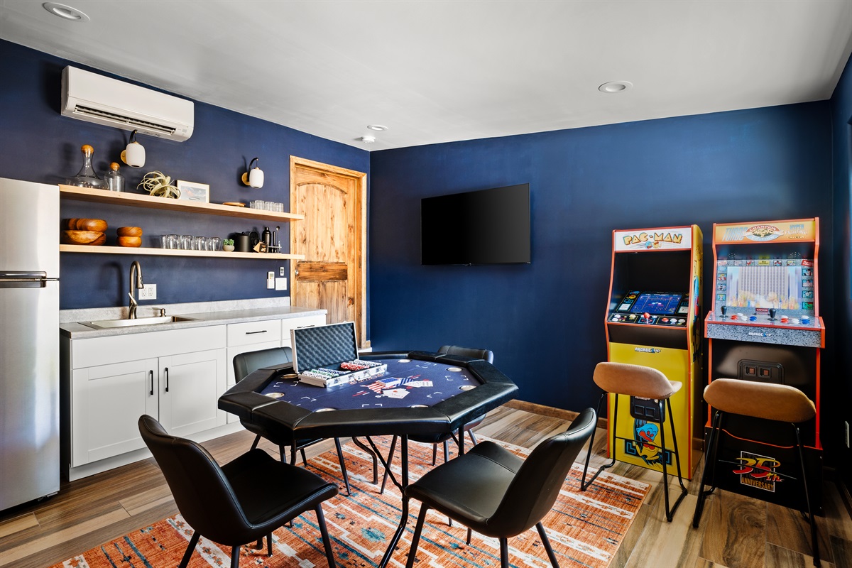 Game room bar with ready-to-play poker table, Smart TV, and arcade machines!