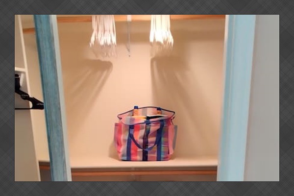 Spacious master closet with plenty of hangers, extra pillows, and two luggage racks.