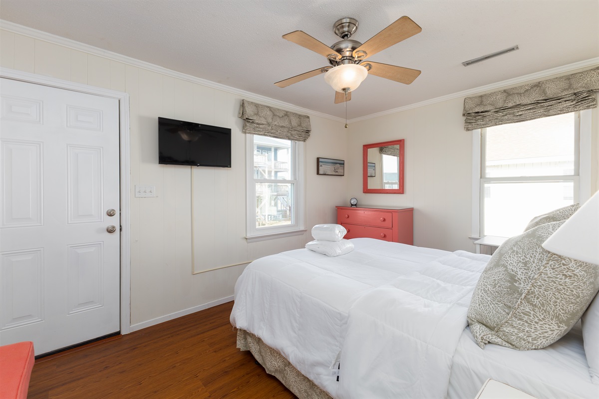 Bedroom 3 features warm lighting and a bold dresser accent