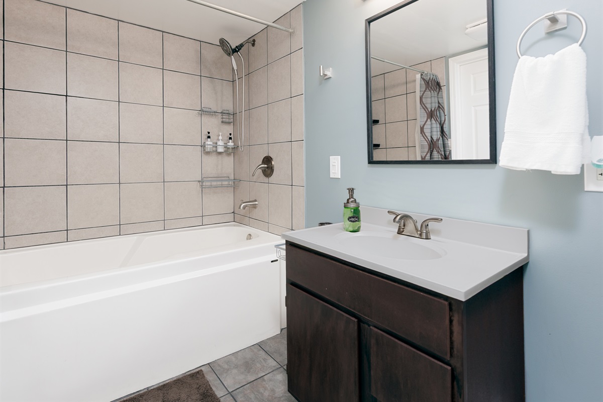 Basement bathroom vanity and sink area with practical storage and lighting. Designed to accommodate the lower-level office & living suite.