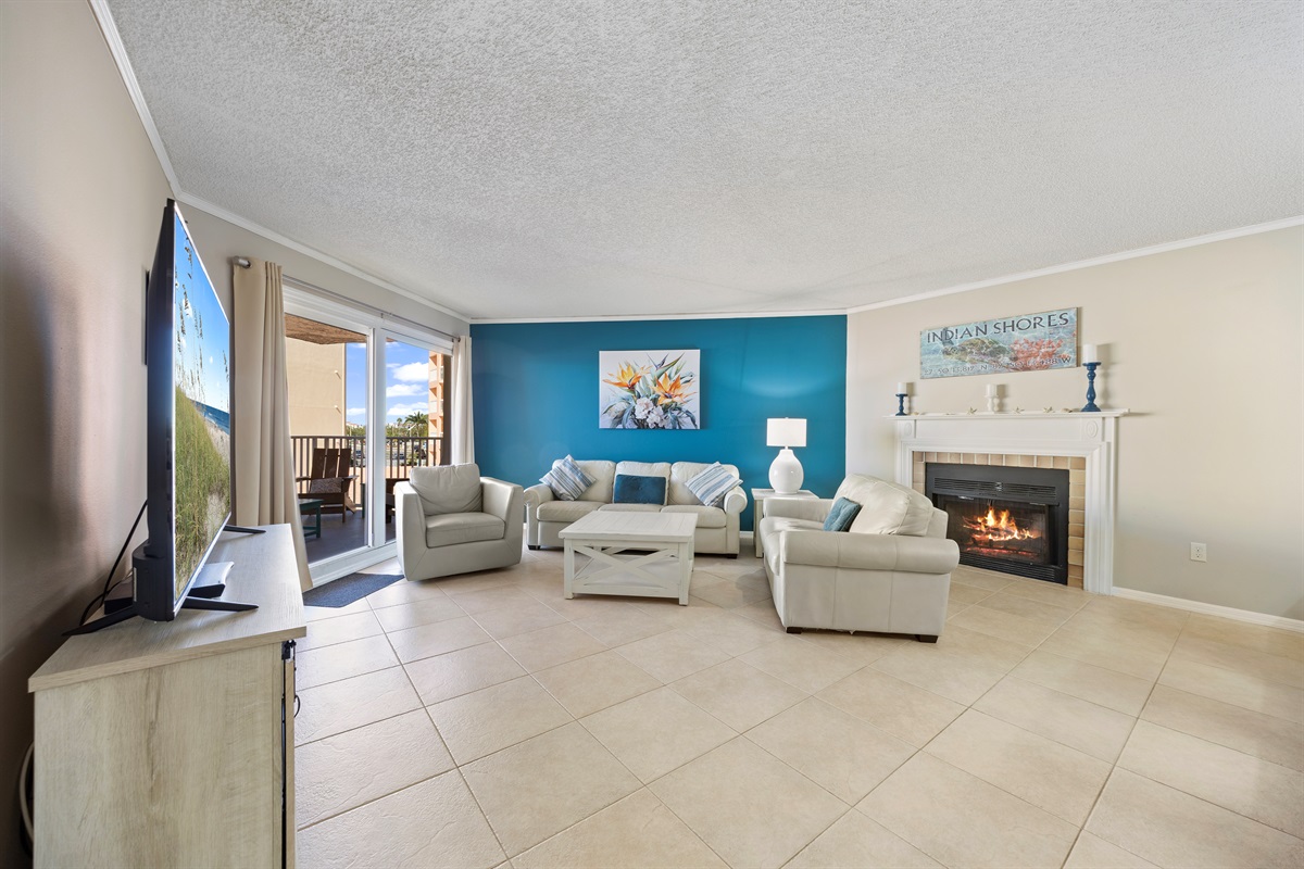 Huge open cozy living room with 70-inch LED Smart TV, Fireplace and Gulf Views