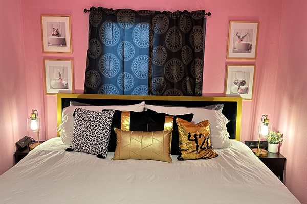 Drift into dreamland on our king-sized bed in this charming pink-themed room, complete with a smart TV for your entertainment.