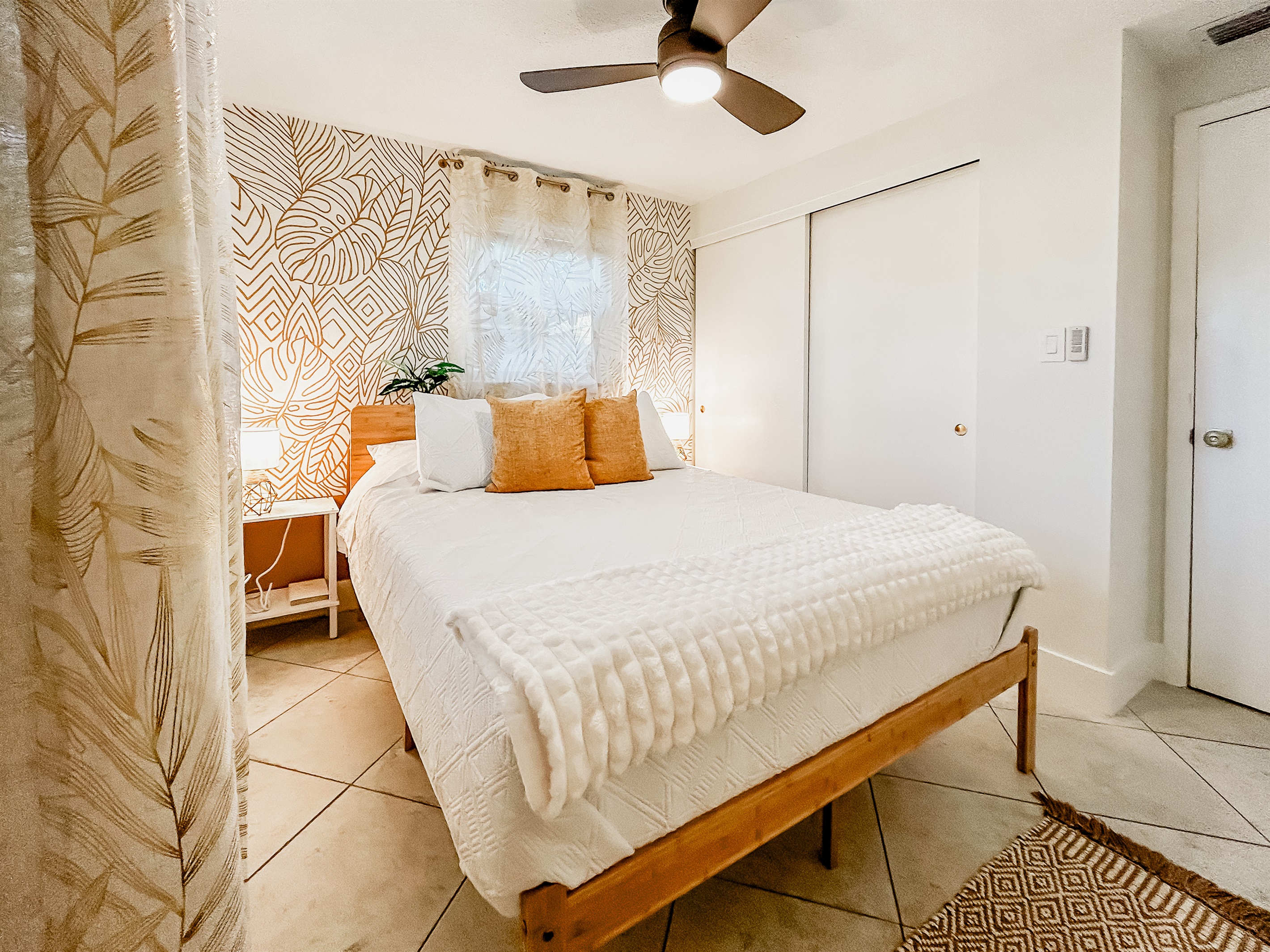 Queen Bedroom with Queen Size Bed, Nightstands with Charging Ports 4 Pillows, Local Artist Mural, Luggage Rack, Laundry Basket & White Noise Fan