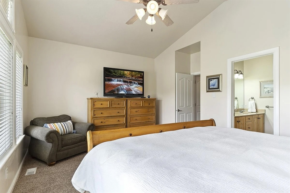 Relax in this comfortable bedroom complete with a cozy seating area—ideal for reading, unwinding, or enjoying a quiet moment.