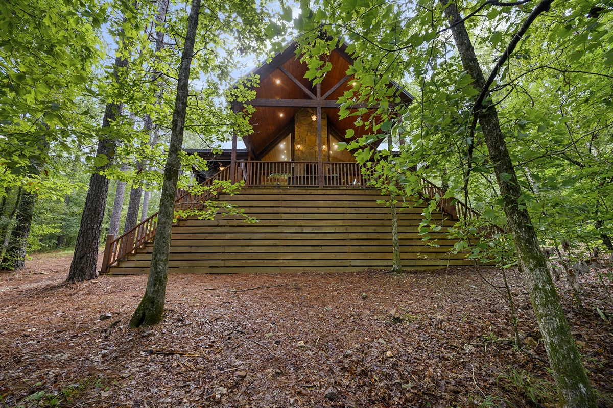 The oversized deck is always a guest favorite. View of back deck taken down by the creek.