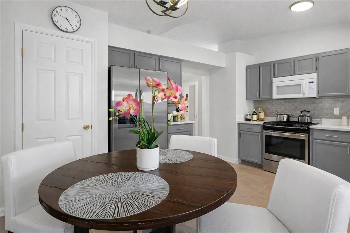 Modern kitchen with stainless steel appliances and a cozy dining area