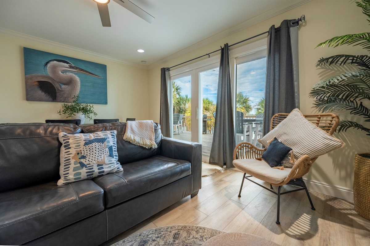 Modern elegance: cozy living room with natural light and serene outdoor vibes.