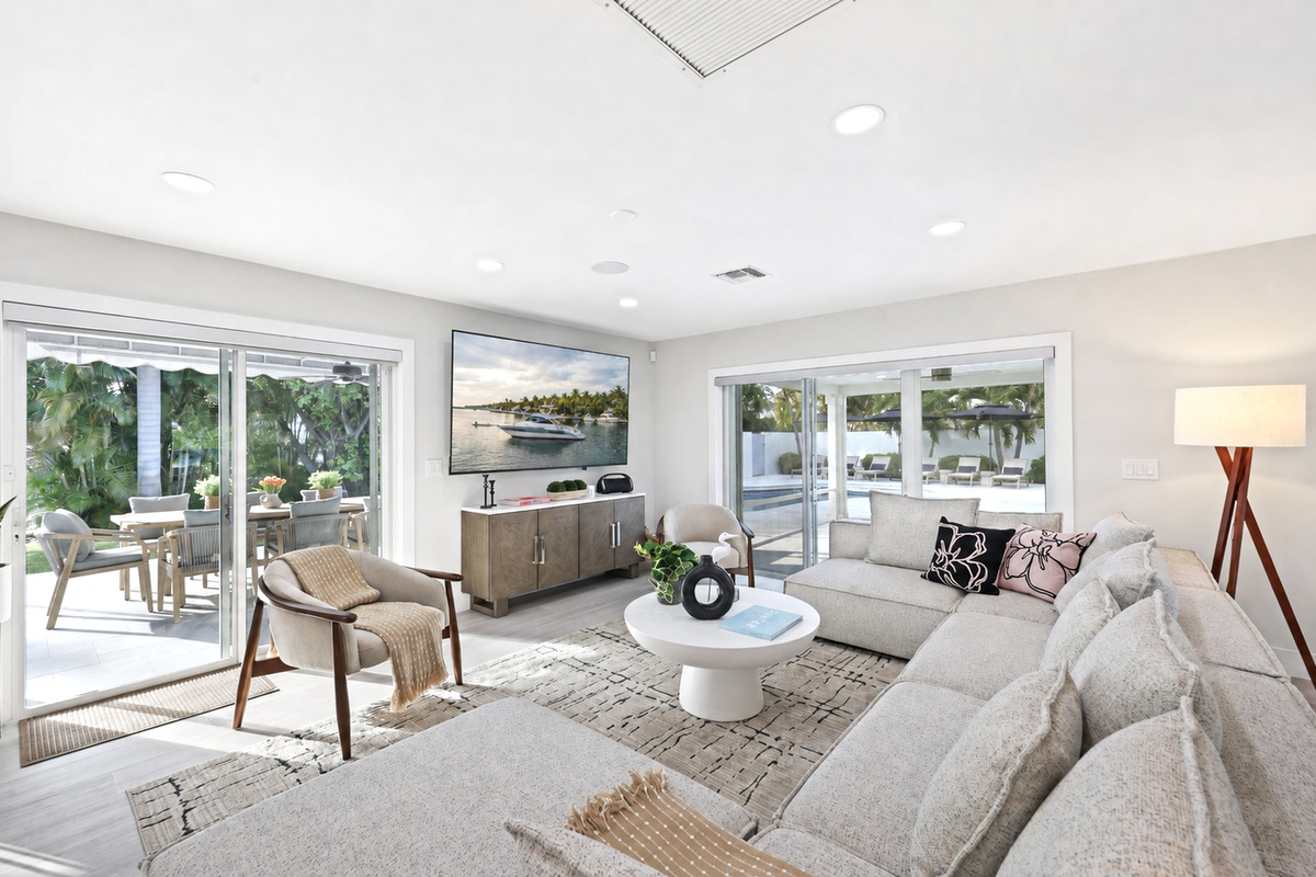 Relax in the living room, watch TV, while the pool and covered patio are right through the wide sliding doors.