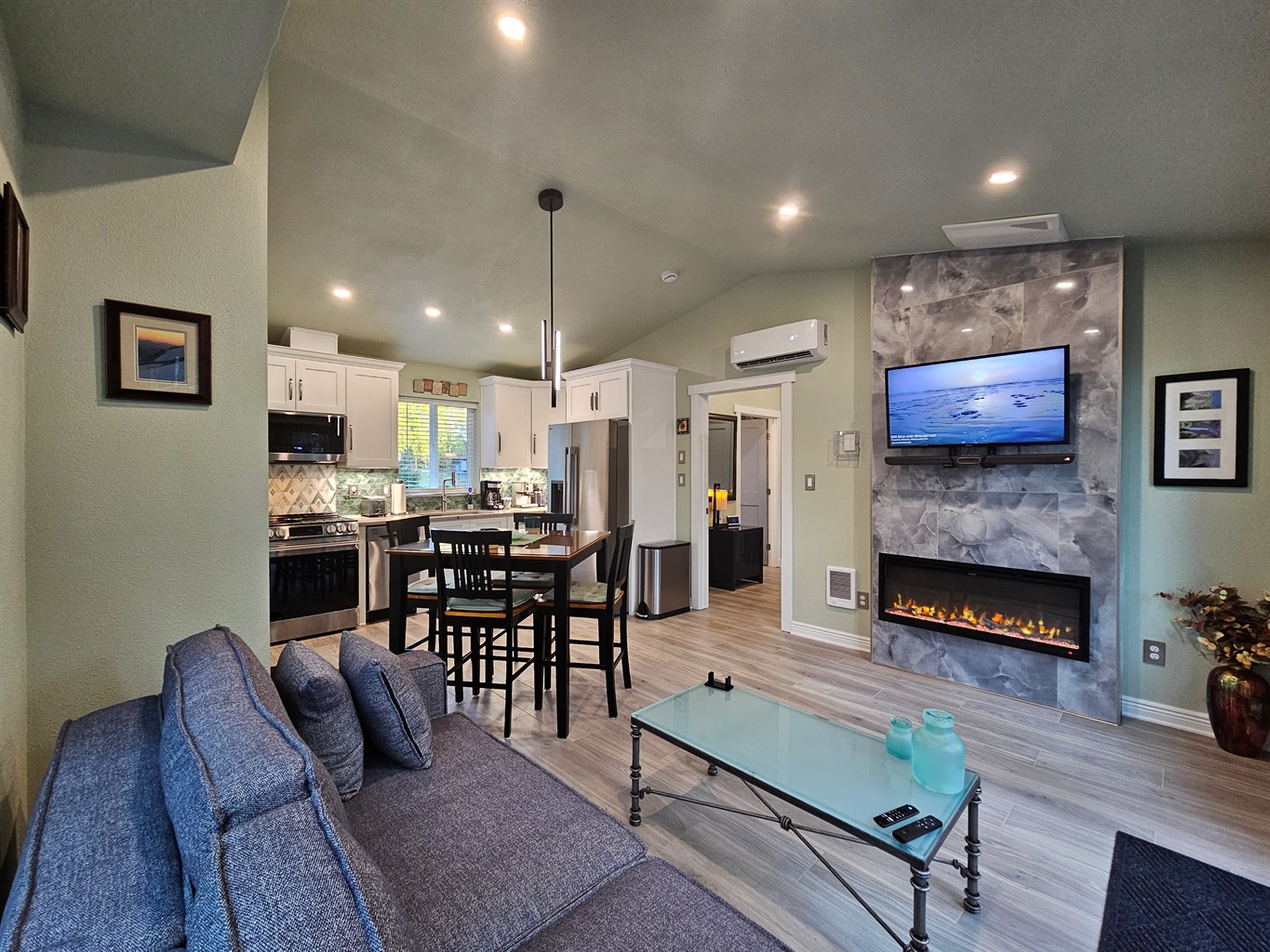 Gather in the heart of the cottage, where an electric fireplace provides ambiance with entertainment from a SmartTV with cable and sound system.  Sofa extends into a queen bed, allowing the cottage to sleep 4.