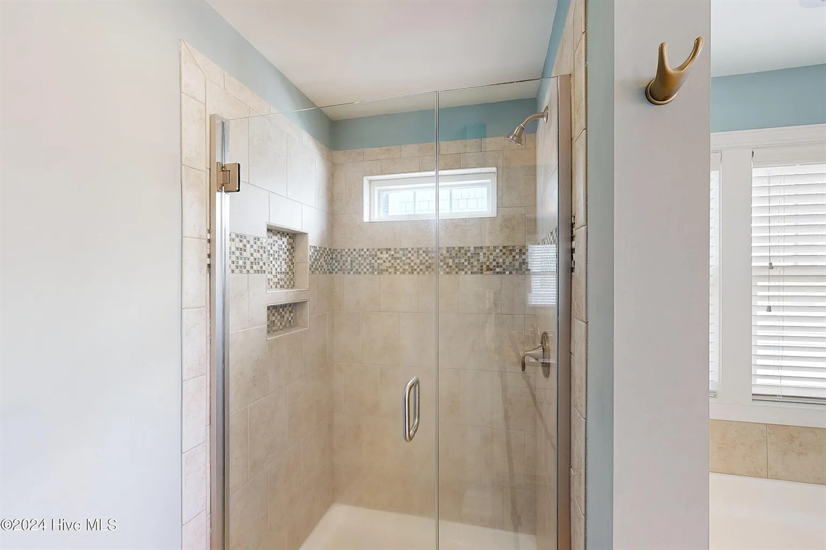 Refresh in the oversized walk-in shower with custom tile work