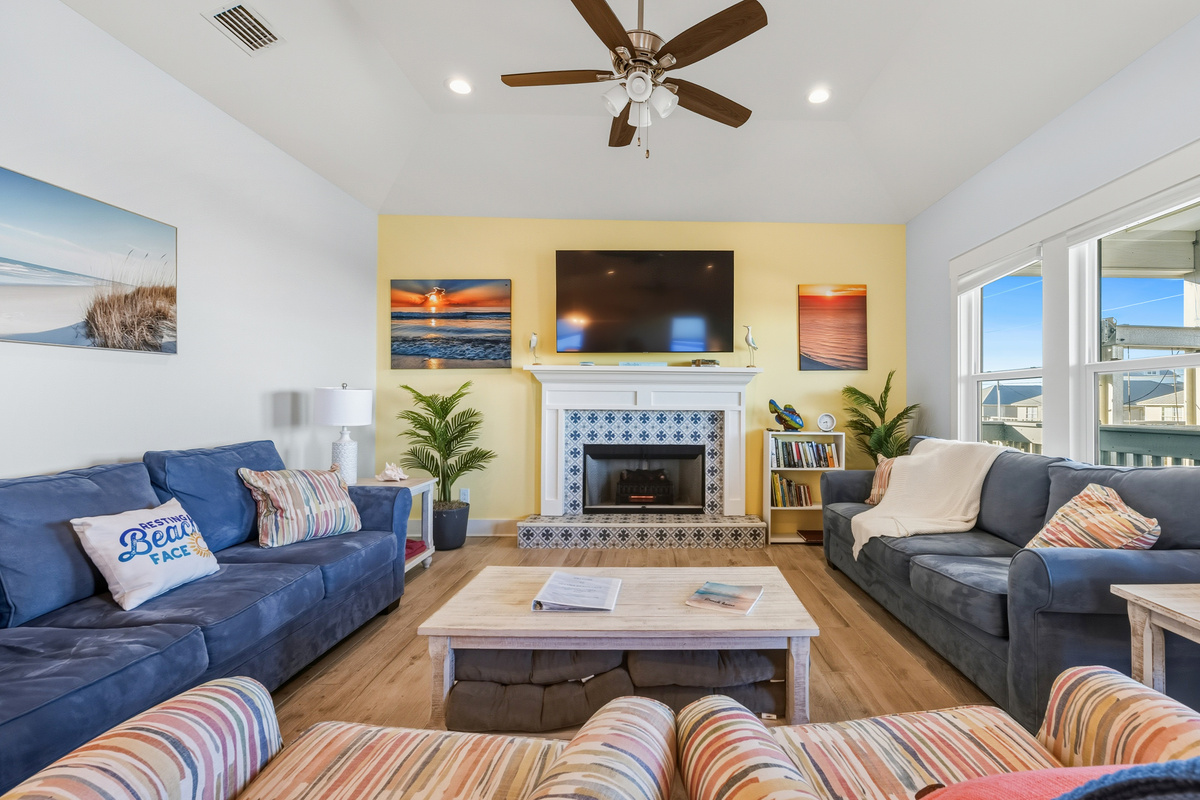 Comfortable living room with 2 sofas, 2 chairs, electric fireplace and a 65" TV with Netflix and YouTubeTV