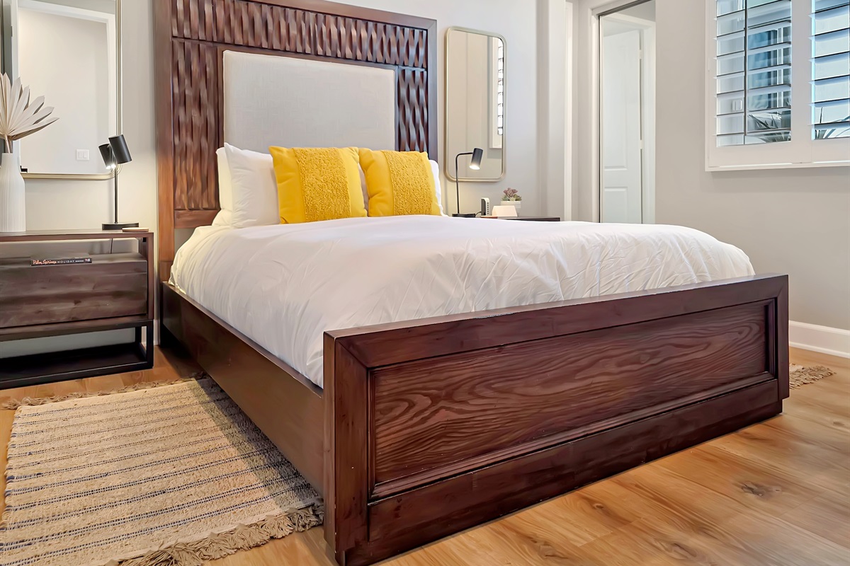 First-floor primary suite features a queen bed, smart TV, ceiling fan, closet and an ensuite bathroom with walk-in shower. (Sleeps 2)