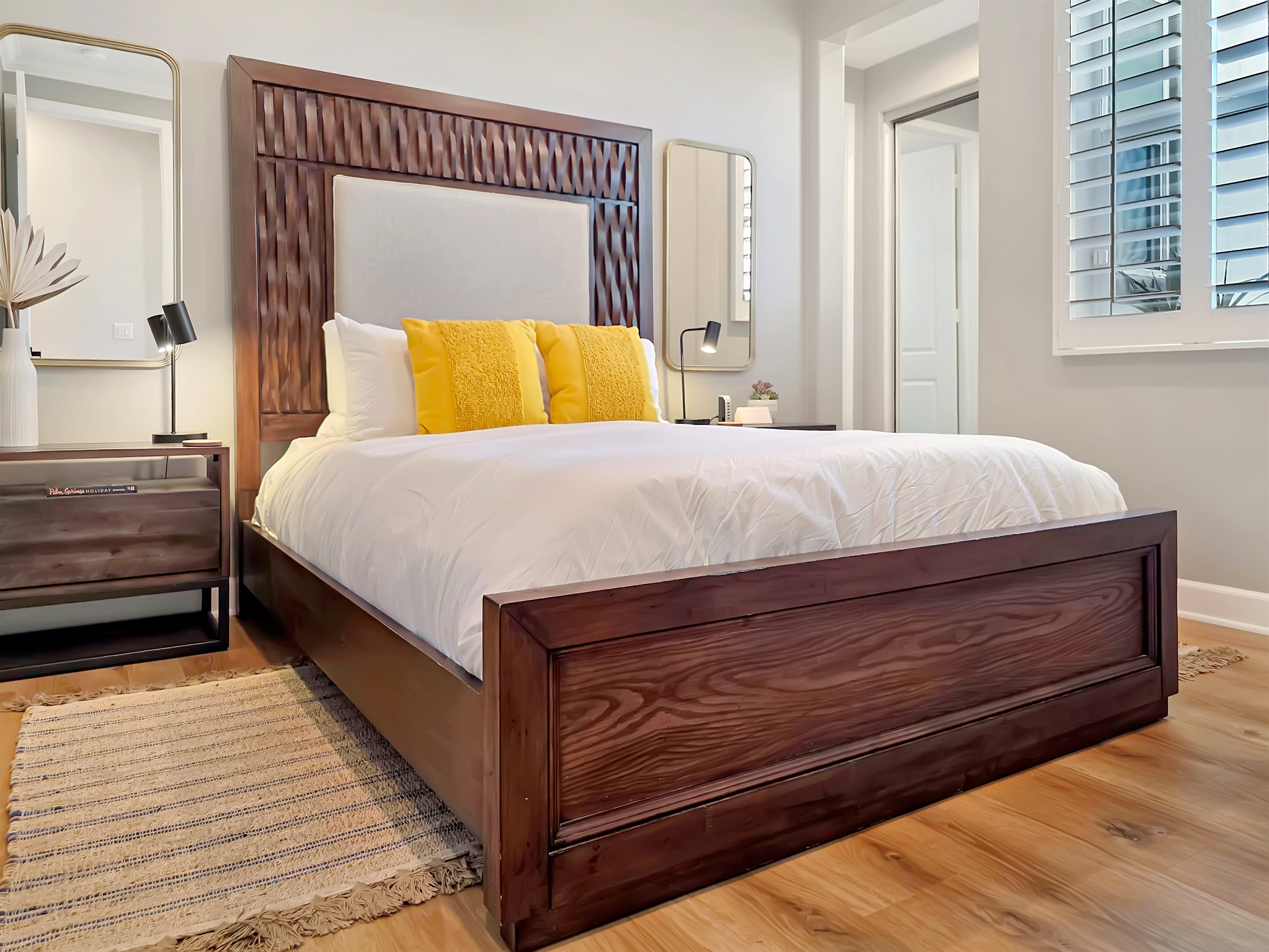 First-floor primary suite features a queen bed, smart TV, ceiling fan, closet and an ensuite bathroom with walk-in shower. (Sleeps 2)