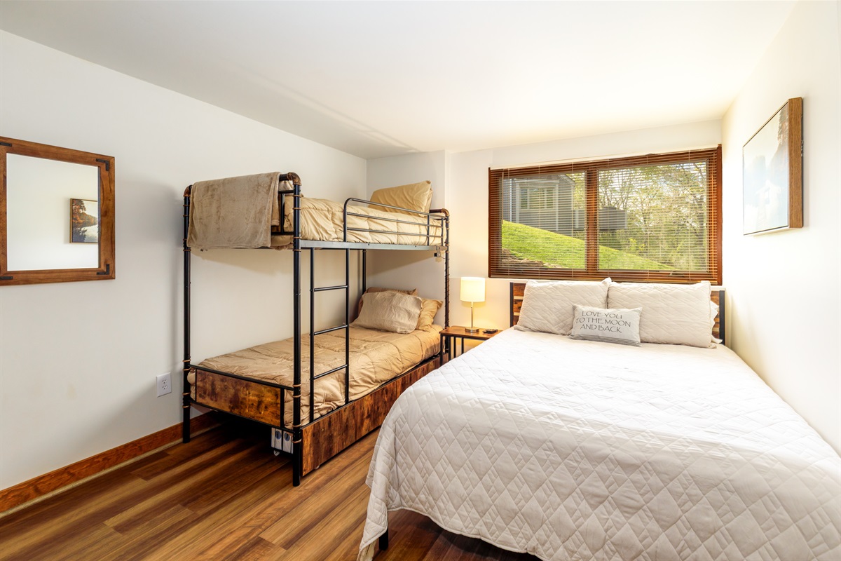 The lower-level bedroom features a Queen bed and Twin bunk beds -- the perfect room for the kids. 