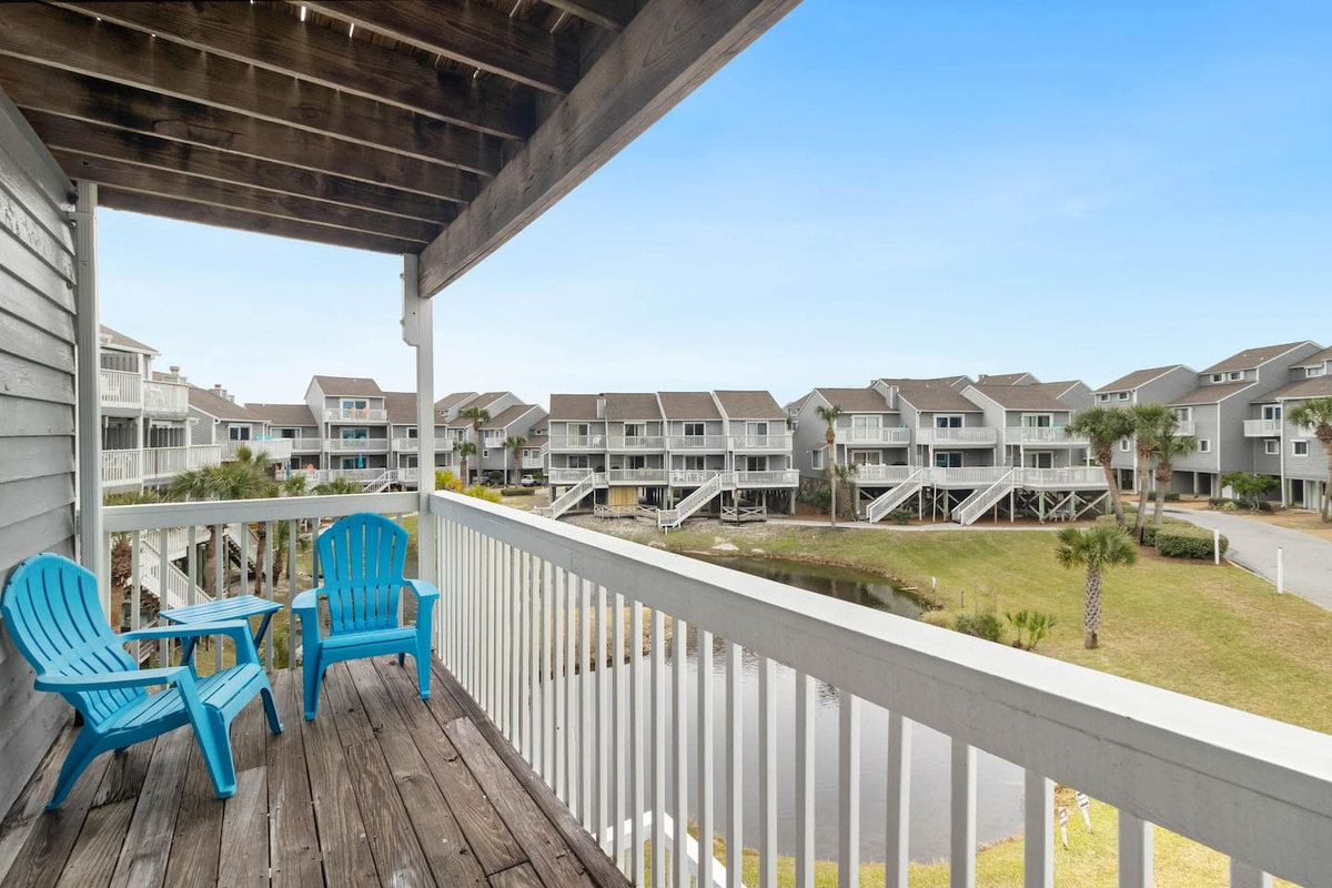 Step onto your private deck off Queen Suite One &mdash; turtle pond below, Gulf glinting in the distance.