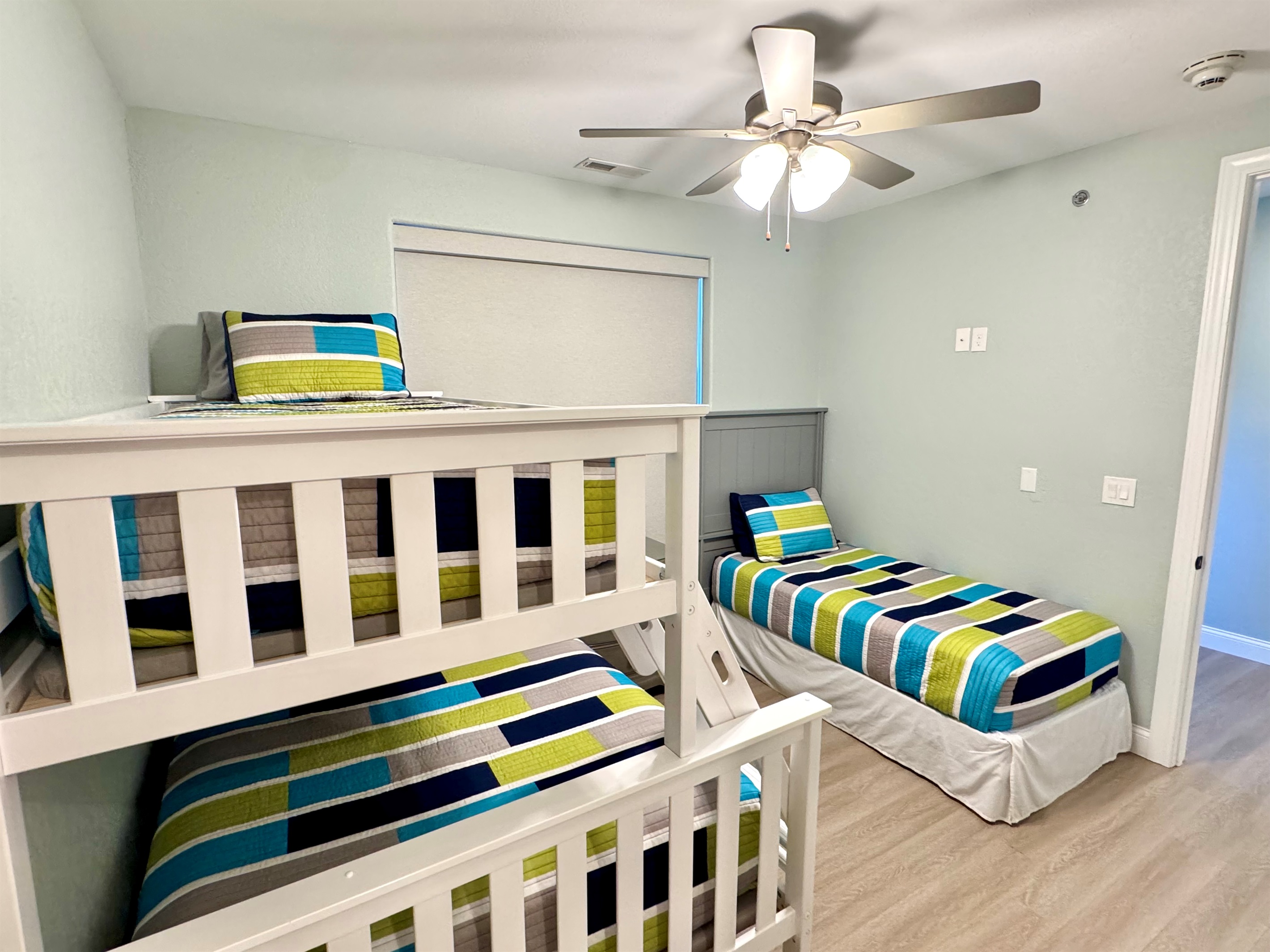Guest Bedroom 3 has a twin bunk bed over a full bed and another twin bed, closet, and private en suite bathroom.