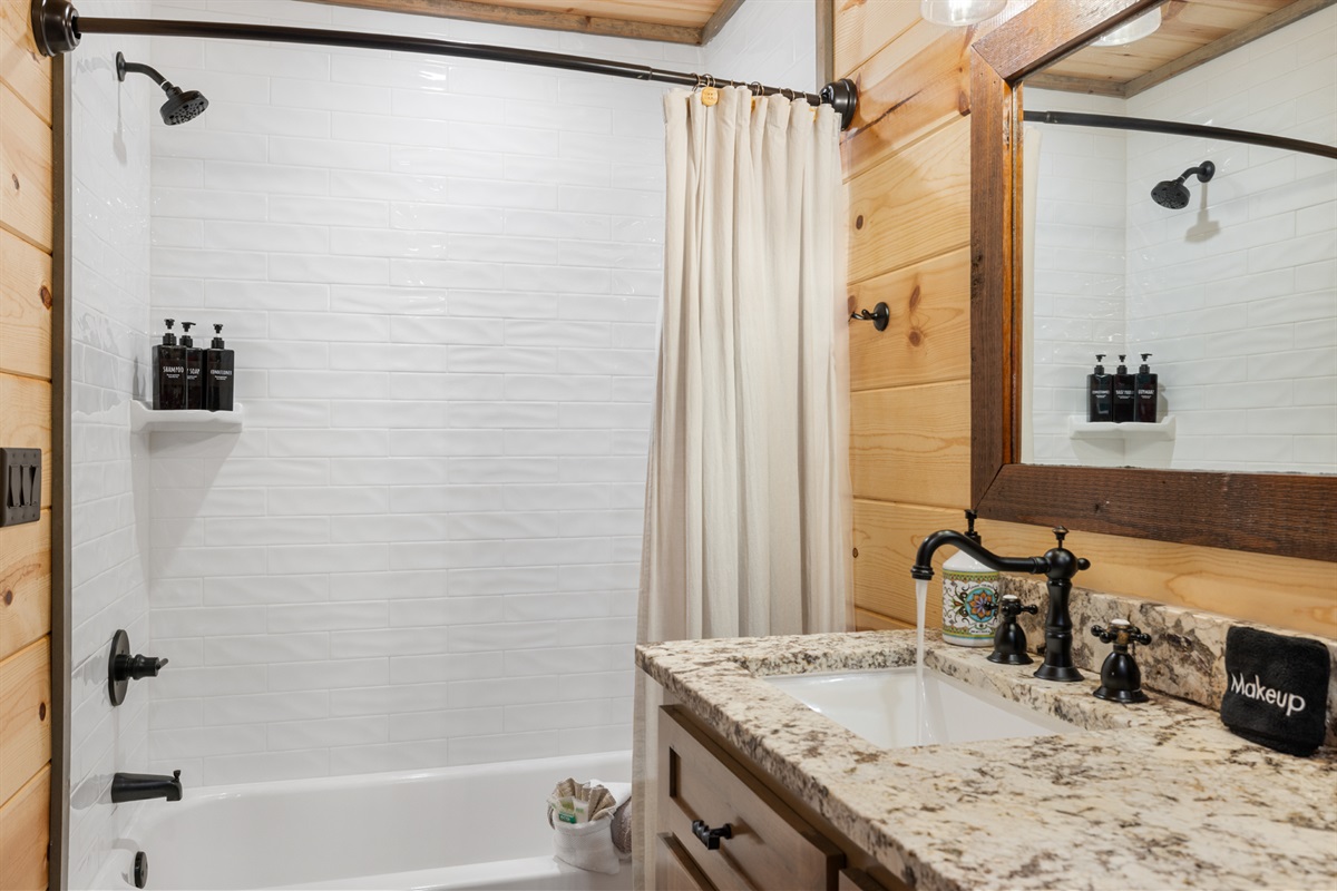 Comfortable guest bathroom with warm wood accents and modern convenience