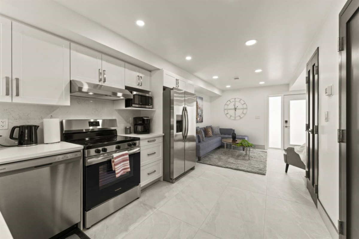 Sleek white cabinetry contrasts beautifully with dark wood floors.