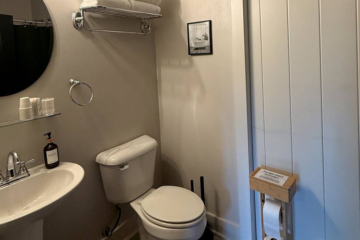 Every retreat needs a pause — this ensuite pairs clean, modern comfort with a touch of bourbon-country humor, reminding guests that even the hardest-working traveler deserves a moment to breathe.