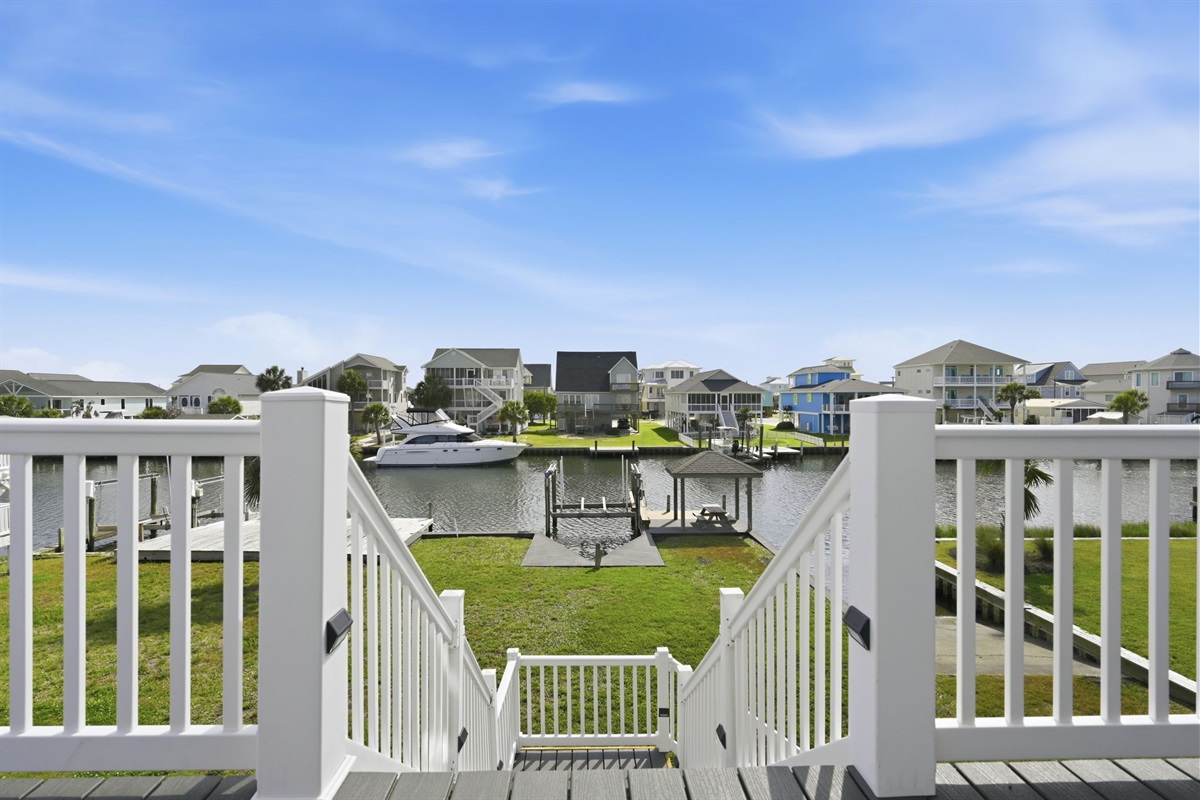 Enjoy beautiful canal views from the spacious upper deck overlooking the private dock