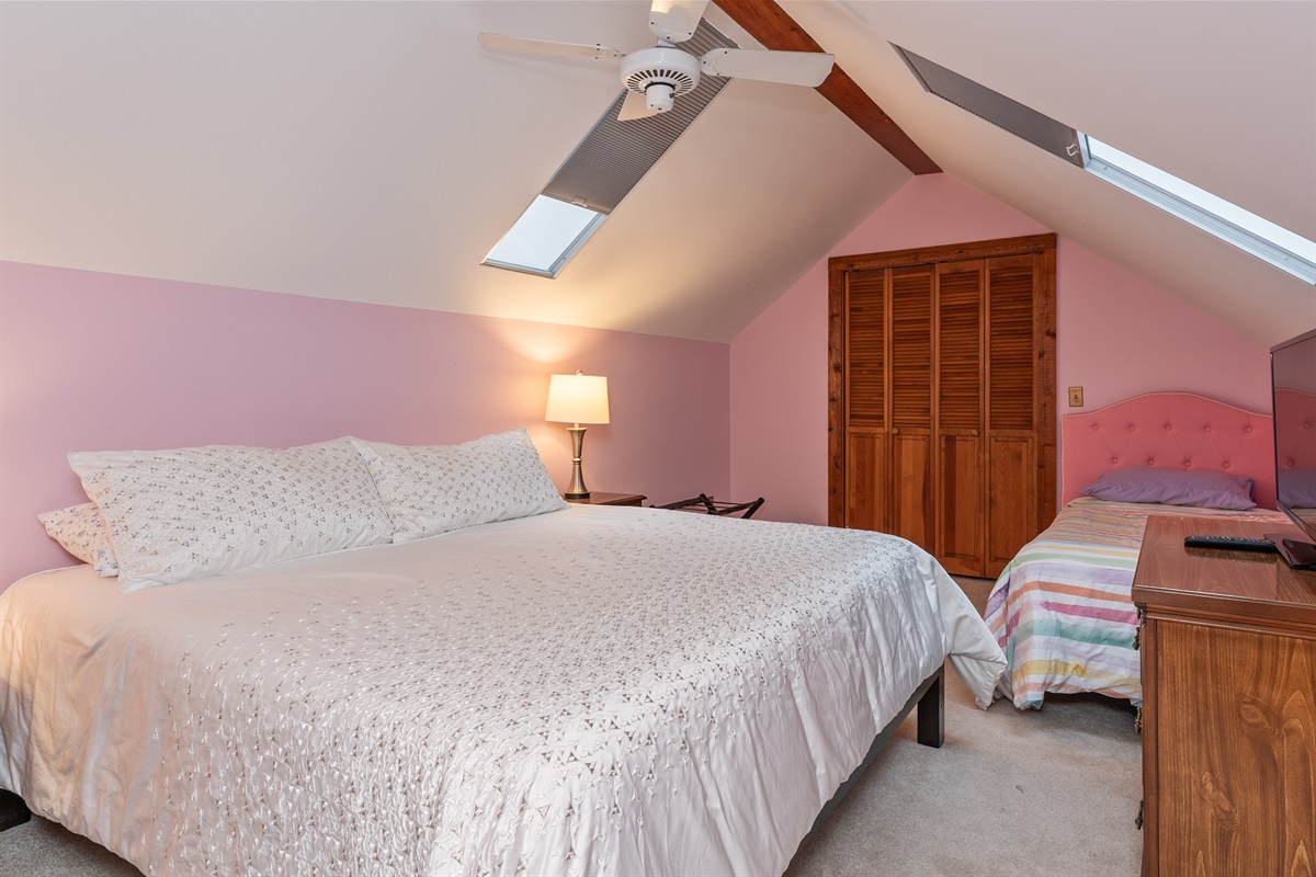 Peaceful bedroom with soft lighting and cozy linens — unwind and recharge in comfort.