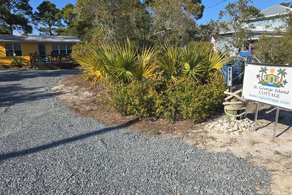 Sign, driveway and cottage.  This is where you turn in when you arrive.