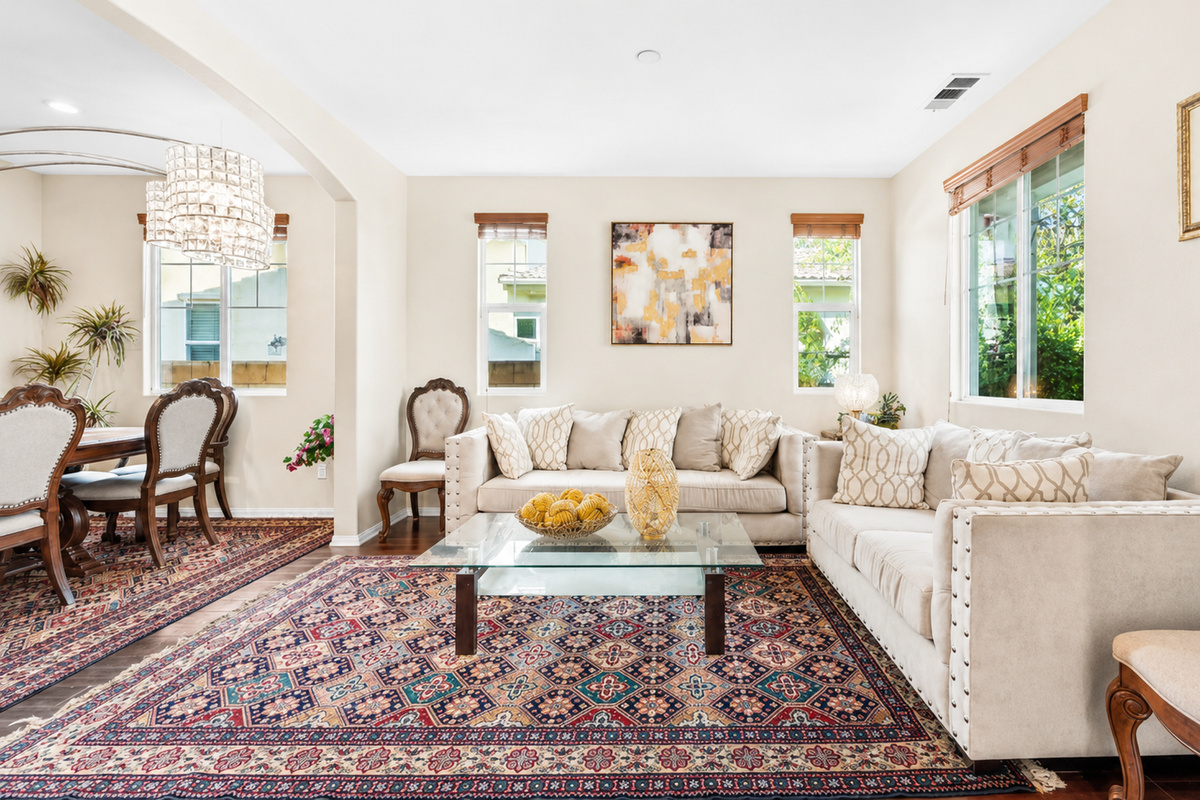 Bright sitting room with soft couches, sunny windows, and a cozy spot to gather.