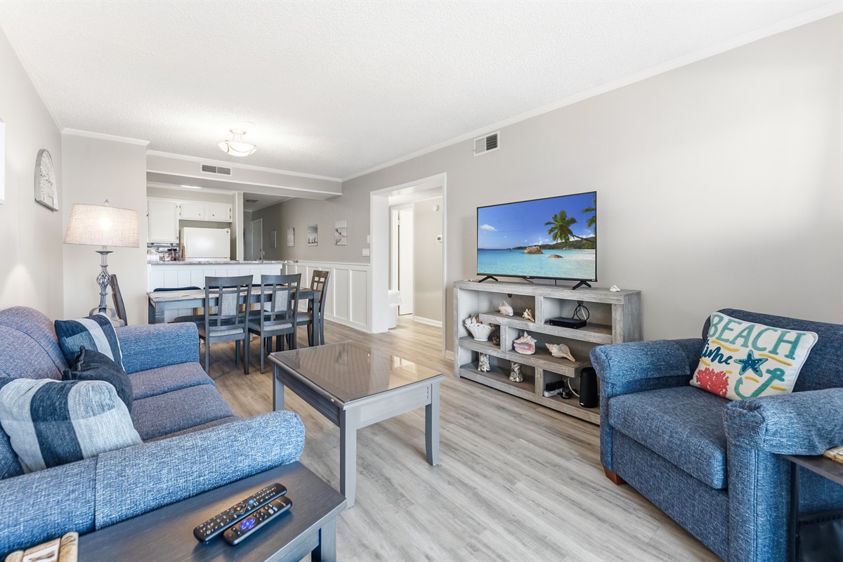 Spacious Living room with seating for everyone and balcony access